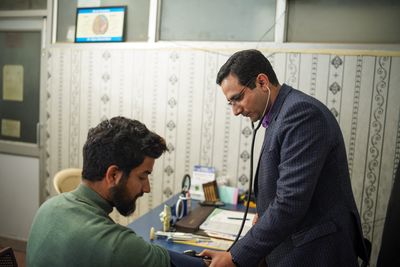 Indian doctor consulting with a patient